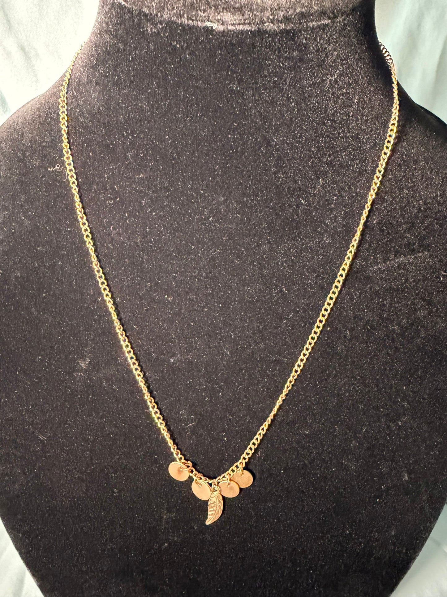 Gold‑Tone Charm Necklace With Mini Disc Accents and Feather Pendant