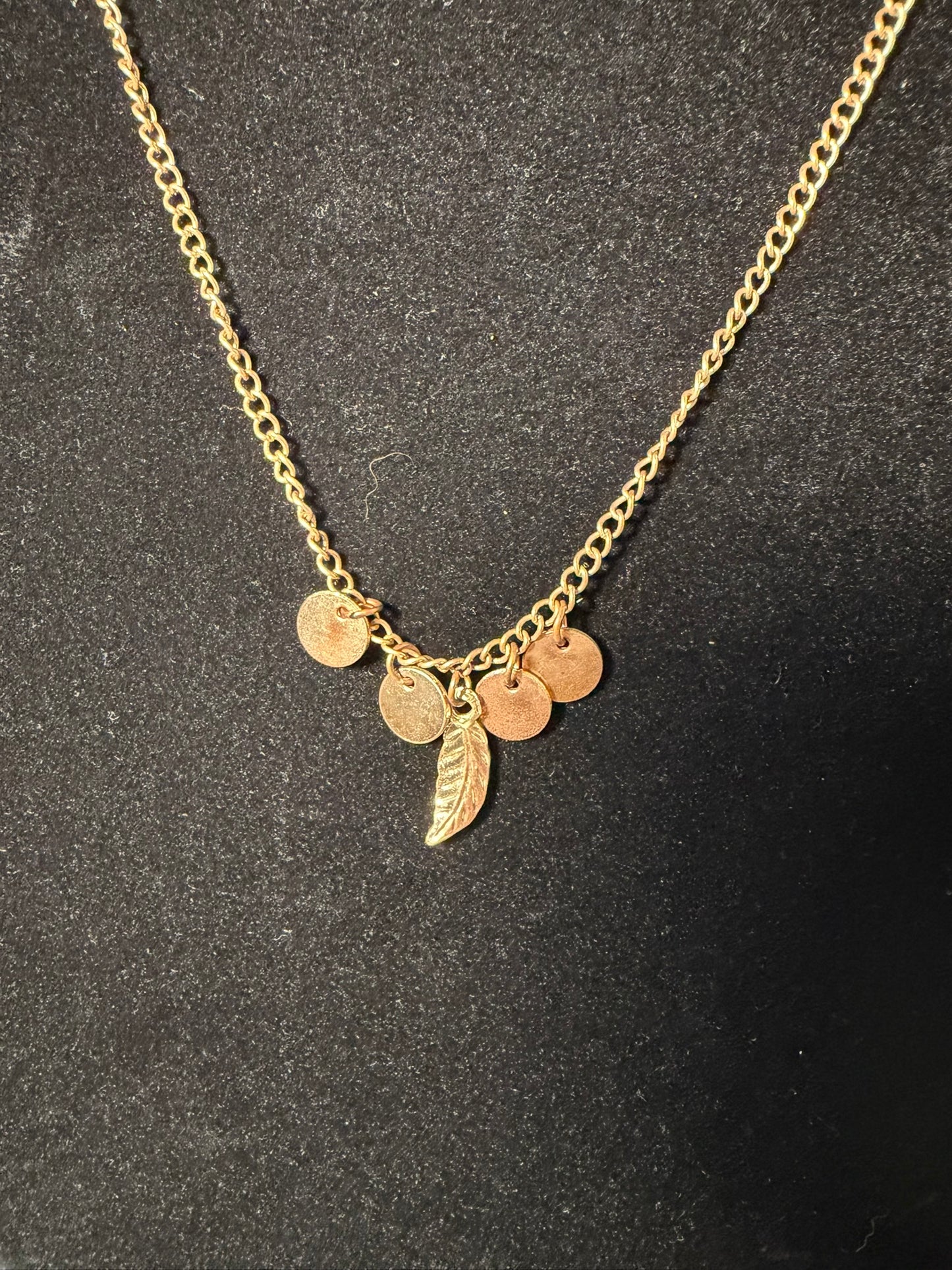 Gold‑Tone Charm Necklace With Mini Disc Accents and Feather Pendant